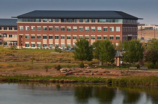 A view of the Rangeview at Centerra buildings from across Equalizer Lake.