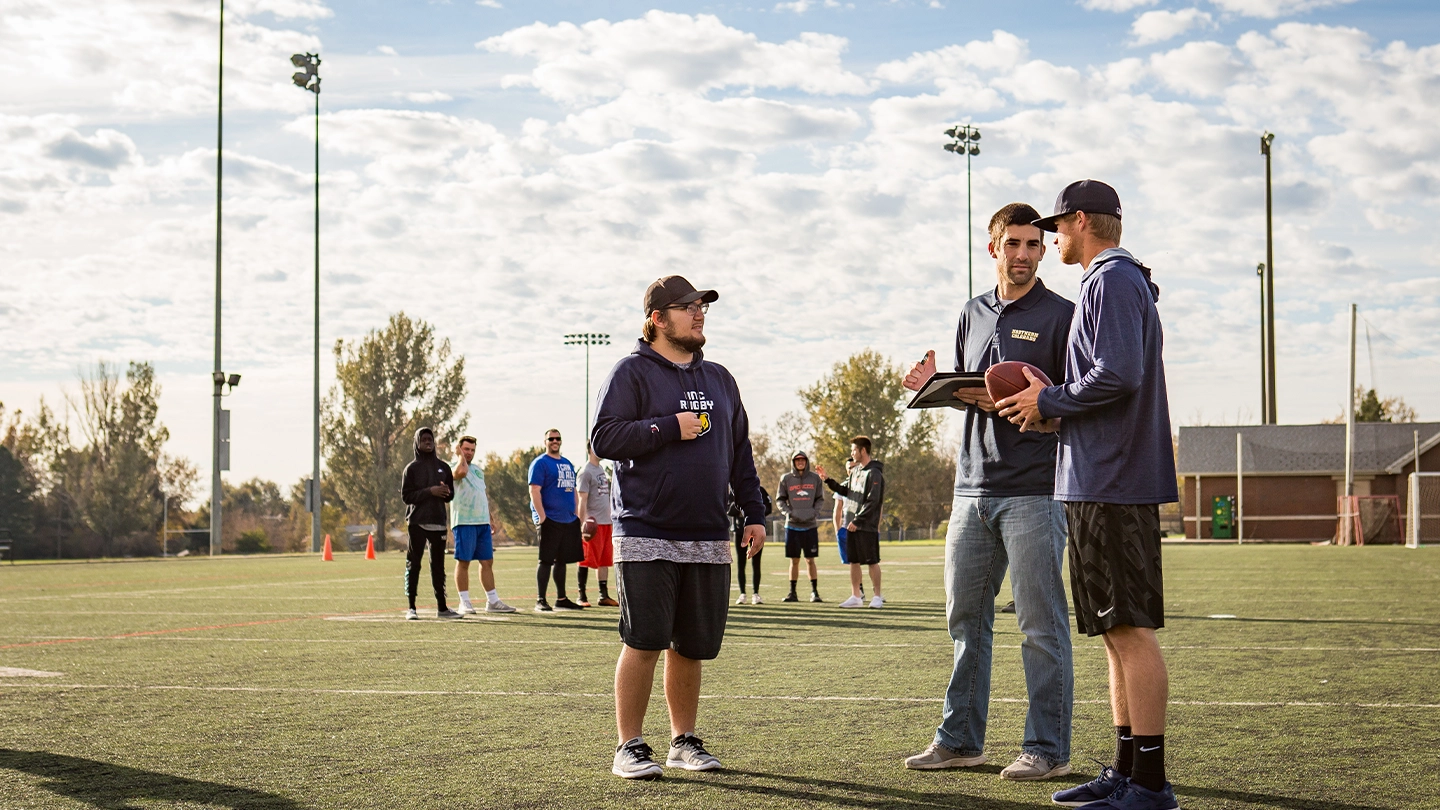 UNC sports coaching session with rugby coaches and team.