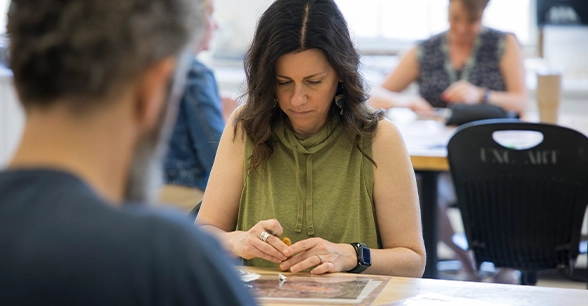 Artist working on a project in class.