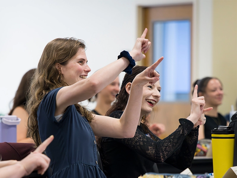 ASL interpreter bachelor's degree students signing in class.