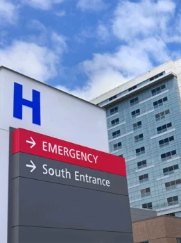 Hospital vehicle entrance sign including emergency room access.