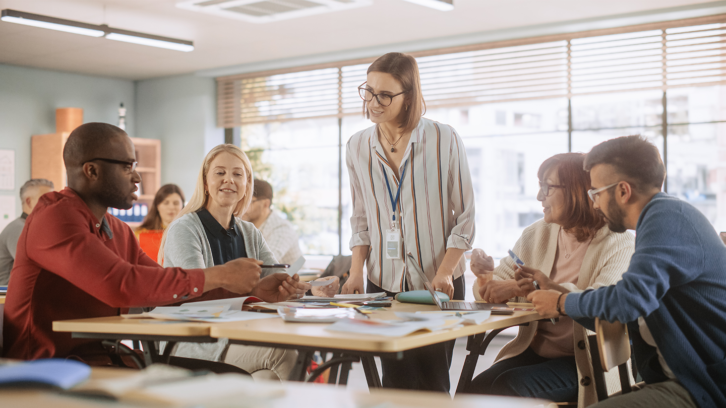 Professional development course with four students and the teacher having a discussion.