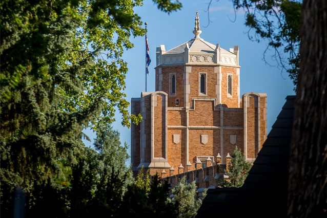 Photo of Gunter Hall through trees on UNC campus