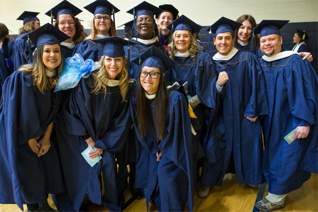 Photo of UNC students posing for a group photo at graduation