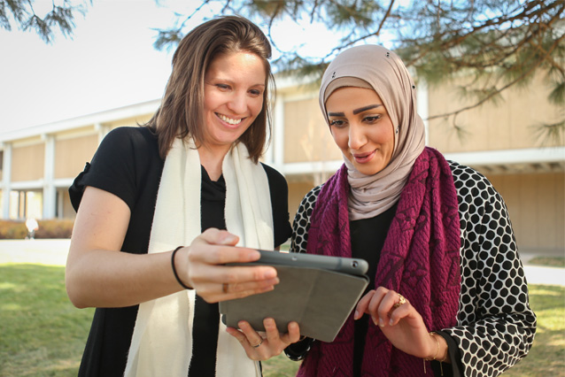 Photo of UNC staff member helping student