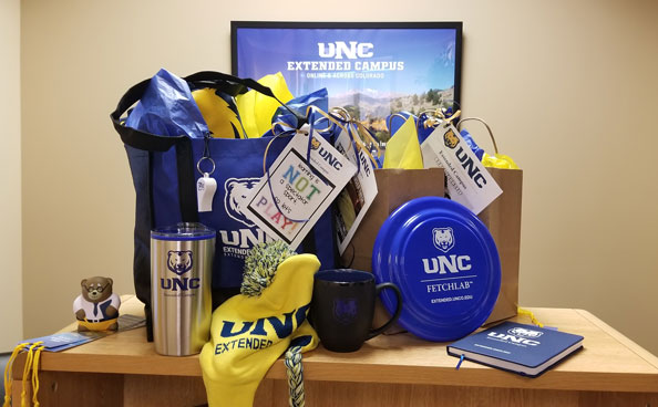 Photo of giveaway items packed into UNC Extended Campus bags