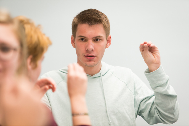 Photo of UNC student learning the ASL sign for "No"