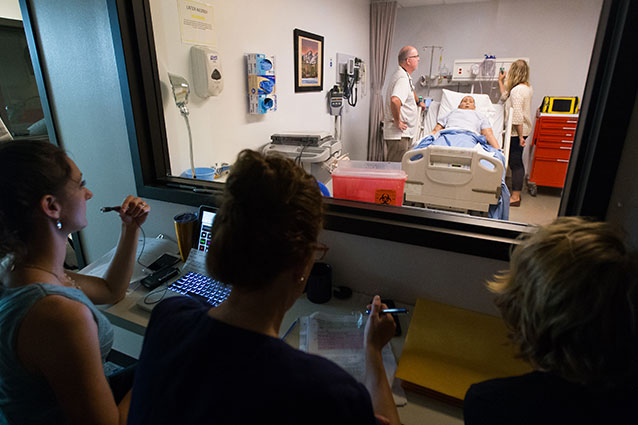 Doctors and nurses observing a patient.