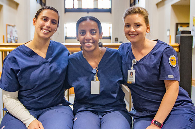 Three nurses sitting on a bench