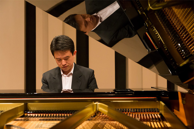 Photo of man playing piano