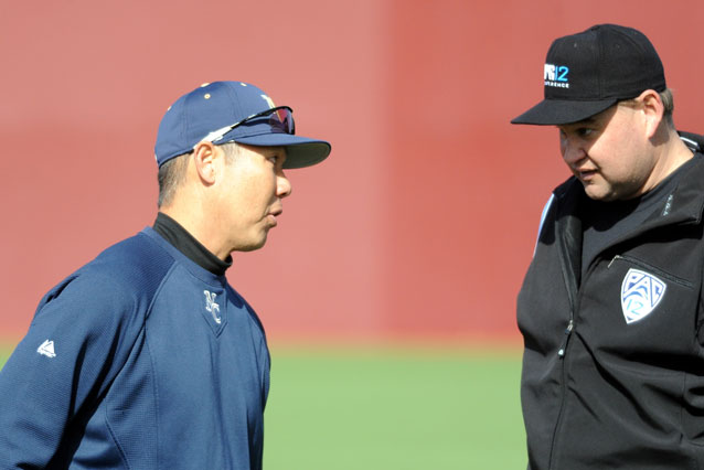 Photo of Coach Iwasaki talking with umpire